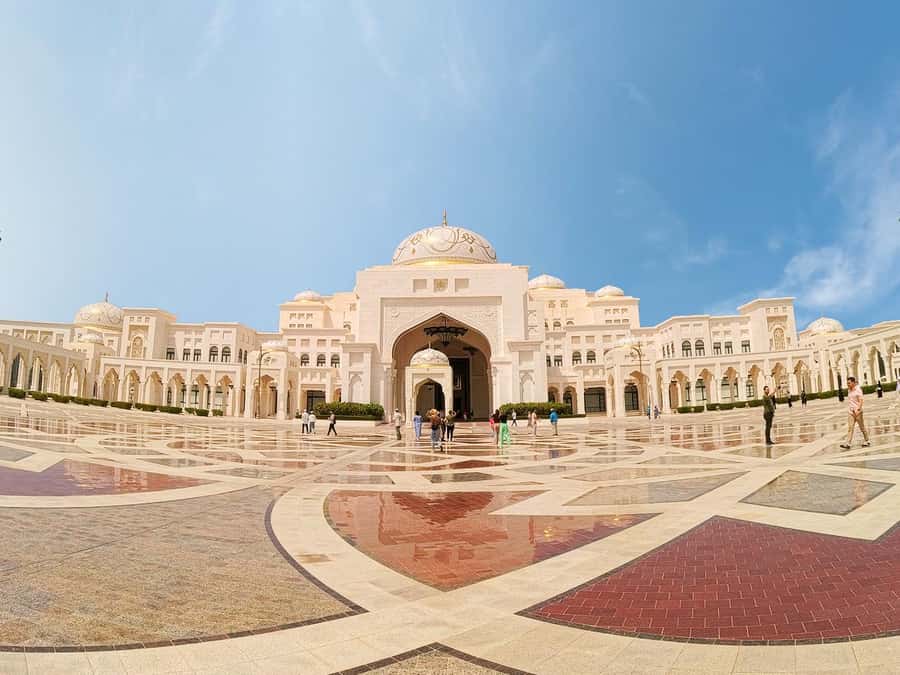 From Dubai: Grand Mosque & Qasr Al Watan Morning Tour - Sheikh Zayed Grand Mosque: white marble, huge scale, and a strict dress code