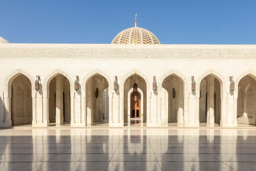 Guided Walking Tour of Sultan Qaboos Grand Mosque in Muscat - Open-air corridors, sandstone columns, and garden views